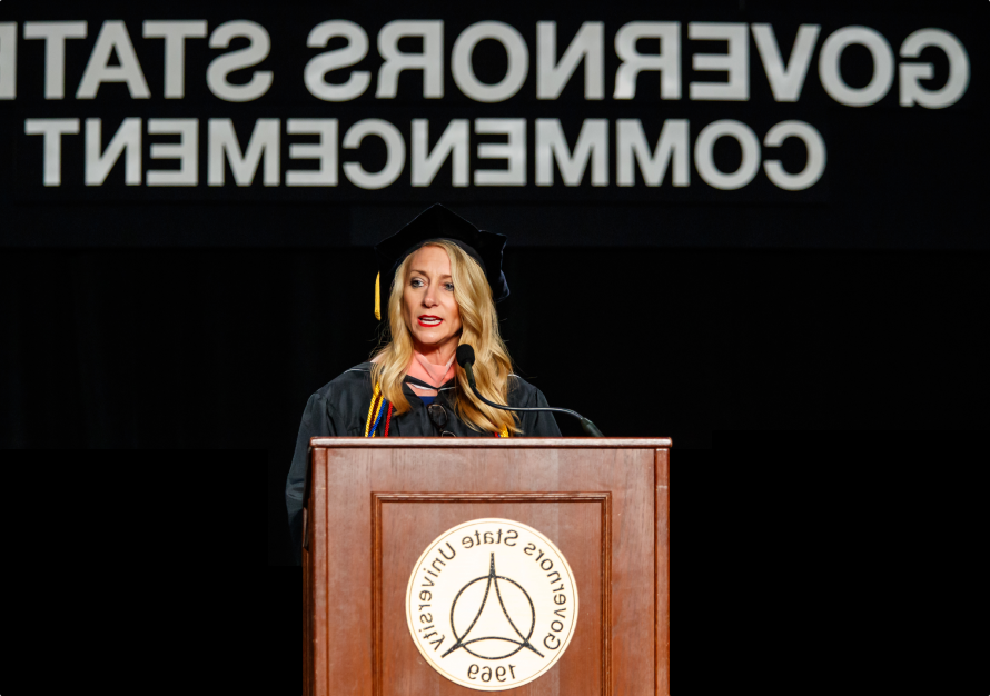 Cristy Gallegos, a GSU alumni, standing at a podium and giving a speech at the 2019 GSU commencement ceremony